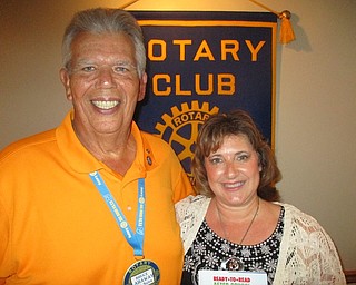 Beth Perry, sales director for the Hampton Inn and Home 2, was guest speaker recently at a Rotary Club of Austintown meeting. The hotels are new in the area and have been successful in gaining new business in this market. Home 2 is designed for both long-term and overnight stays, while the Hampton is mostly for commercial and family travelers. Above, from left, Bruce Laraway, Rotary chapter president, makes a book presentation to Perry. The book will be placed in the Austintown Elementary School library.