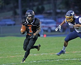             ROBERT  K. YOSAY | THE VINDICATOR..McDonald at Mineral Ridge.Mineral Ridge Ram #1 Baptiste DeCosta  goes for a first down during first quarter action as McDonald #83 Tyrese Johnson pursues