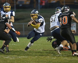             ROBERT  K. YOSAY | THE VINDICATOR..McDonald at Mineral Ridge.Big Hole as McDonald #10Josh Celli goes for first down and big yards in the first quarter -Min Ridge #7 Joe Rozzi and #10 Jared Miller  next to him are team mates#2 Ryan Scala -#57 Calvin Wolford