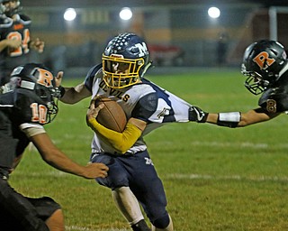             ROBERT  K. YOSAY | THE VINDICATOR..McDonald at Mineral Ridge..Josh Celli #10  is grabbed by #8Min Ridge Jacob Lesko and #10 Min Ridge Jarred Miller.as he sets up the third quarter TD