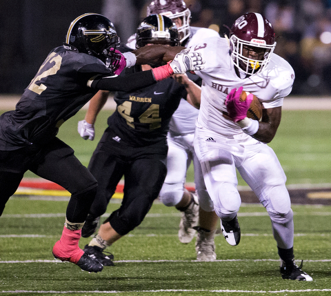 MICHAEL G TAYLOR | THE VINDICATOR- 10-06-17  FOOTBALL Boardman Spartans vs Warren Harding, Harding High School, Mollenkopf Stadium, Warren, OH..1st qtr., Boardman's Domonhic Jennings #3 stiff arms Harding's Tyler Day #32 on his way to a 1st down