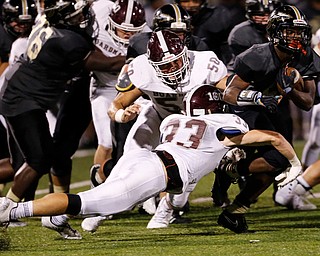 MICHAEL G TAYLOR | THE VINDICATOR- 10-06-17  FOOTBALL Boardman Spartans vs Warren Harding, Harding High School, Mollenkopf Stadium, Warren, OH..2nd qtr., Harding's Jujuan Forte #5 is tackle for by Boardman's Steven Amstutz #50 and Connor Miller #33.