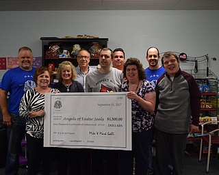 Mike and Mark Sahli presented a check recently for $1,500 from the 19th annual M & M Golf Classic to the Angels of Easter Seals. The tournament took place Sept. 3 at Mill Creek Park golf course. The Sahli brothers founded the M & M Golf Classic to benefit local charities throughout the Mahoning Valley. Clients of the Easter Seals skill-development program will benefit from this year’s donation. For more information about Easter Seals, call 330-743-1168 or visit www.mtc.easterseals.com. Above, from left, are Mike Sahli; Gerogeann Buonpane, president of the Angels of Easter Seals; Lynn Sahli, former president of the Angels of Easter Seals; Tim Nelson, Easter Seals president and CEO; Joey Serich, skill development client; Dan Sefcik, skill development assistant; Danielle Madden, skill development client; Mark Sahli, and David Rosko, skill development client.
