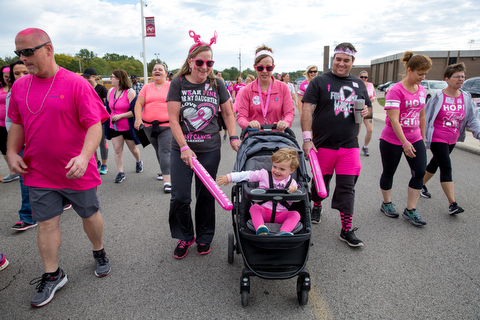 Rita White, (left) of Camel, James and Laura Ridge of Austintown and Brady, 2 walk for breast cancer awareness at Austintown High School on Saturday.