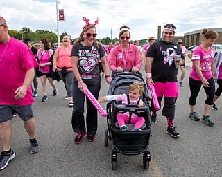 Rita White, (left) of Camel, James and Laura Ridge of Austintown and Brady, 2 walk for breast cancer awareness at Austintown High School on Saturday.