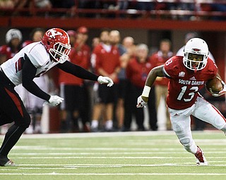 University of South Dakota wide receiver Shamar Jackson (13) jukes past a Youngstown State defender after a reception during the first half at the DakotaDome on Saturday, Oct. 7, 2017 in Vermillion, S.D.