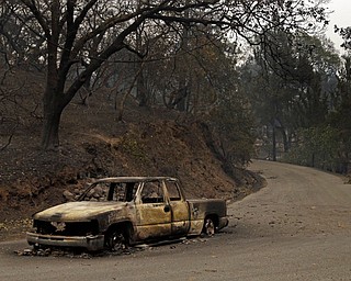 Remains of a car seen on Crystal Drive Monday, Oct. 9, 2017, in Santa Rosa, Calif. Wildfires whipped by powerful winds swept through Northern California early Monday, sending residents on a headlong flight to safety through smoke and flames as homes burned. (AP Photo/Ben Margot)