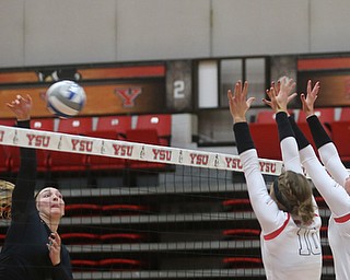 Wright State University outside hitter Katie Klusman (12) goes up for the spike against Youngstown State University Outside Hitter Erin Kalahar (10) and Youngstown State University Outside Hitter Sam Brown (20) during the first set as Wright State University takes on Youngstown State University, Wednesday, Oct. 11, 2017, at the Beeghly Center at Youngstown State University in Youngstown. The Raiders won the set 3-1, loosing set 1 30-32 and winning set 2 25-16, set 3 25-17 and set 4 25-22...(Nikos Frazier | The Vindicator)..