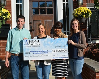 Home Savings Charitable Foundation recently donated $25,000 to Youngstown Neighborhood Development Corporation. The funds will be used for the Community Financial Literacy Initiative. The initiative is designed to provide free services and financial counseling to people who are seeking to own a home or start a business.  For more information regarding YNDC, call 330.480.0423 or visit www.yndc.org. At right, from left, are Ian Beniston, YNDC executive director; Tammi Neuscheler, housing client manager, YNDC; June Johnson, CRA assistant, Home Savings; and Tiffany Sokol, housing director, YNDC.
