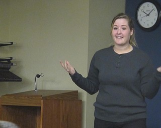 Neighbors | Zack Shively  .Amy Burkard prepared the children to get ready to perform "Head, Shoulders, Knees, and Toes" at Boardman library on Aug. 16 as a part of their Puppet Tales event.