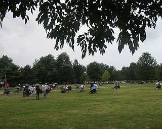Neighbors | Zack Shively.People sat under umberellas and trees to stay dry during Boardman High School Jazz Ensemble's concert at Boardman park on Aug. 24.