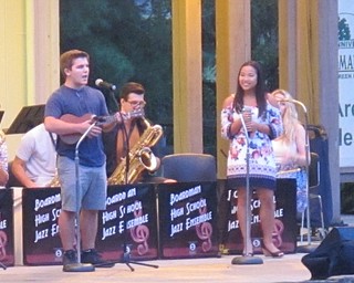 Neighbors | Zack Shively.Two students sing "Bring Me Sunshine" in the rain at Boardman Park on Aug. 24 during the Boardman High School Jazz Ensemble's Muisc in the Park concert. The band performed a wide variety of songs, ranging from big band to Sinatra to this ukulele song.