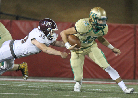 William D. Lewis the Vindicator Boardmam's Neil Bevacqua(32)get a hand on  Ursuline's Jared Fabry(13)) during 1rst half action 10-12-17 at Stambaugh.