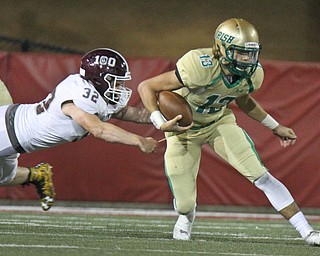 William D. Lewis the Vindicator Boardmam's Neil Bevacqua(32)get a hand on  Ursuline's Jared Fabry(13)) during 1rst half action 10-12-17 at Stambaugh.