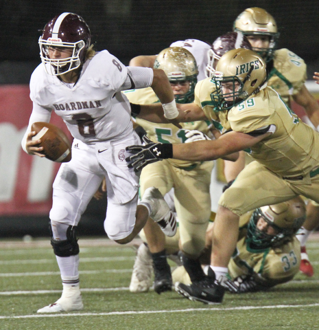 William D. Lewis the Vindicator Boardman QB Mike O'Horo?(8) is tackled by Ursuline's Jason Bell(59) during 1rst half action 10-12-17 at Stambaugh.