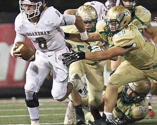 William D. Lewis the Vindicator Boardman QB Mike O'Horo?(8) is tackled by Ursuline's Jason Bell(59) during 1rst half action 10-12-17 at Stambaugh.