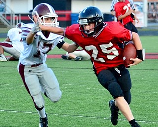 Neighbord | Submitted .Canfield Village Middle School  tailback Ryan Schneider stiff-armed a would-be Glenwood tackler.