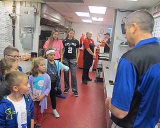 Neighbors | Zack Shively.Union Elementary Principal Michael Masucci showed his students and two high school students the inside of Cocca's Pizza on Oct. 6. He pointed at each area and explained how they make pizza.