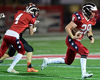 NILES, OHIO - OCTOBER 12, 2017: Niles' Robbie Savin, right, runs the bal after picking up a block from Trent Johnson during the first half of their game Thursday night at Niles McKinley High School. DAVID DERMER | THE VINDICATOR