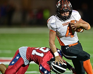 NILES, OHIO - OCTOBER 12, 2017: Howland's Jackson Deemer stiff arms Niles' Jayden Davis, left, while fighting for extra yardage during the first half of their game Thursday night at Niles McKinley High School. DAVID DERMER | THE VINDICATOR