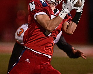NILES, OHIO - OCTOBER 12, 2017: Niles' Alex Lawrence catches a pass infant of Howland's Jonny Elliot during the first half of their game Thursday night at Niles McKinley High School. DAVID DERMER | THE VINDICATOR