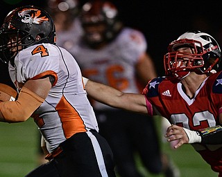NILES, OHIO - OCTOBER 12, 2017: Howland's Jackson Deemer runs away from the grasp of Niles' Preston Turner on his way into the end zone to score a touchdown during the first half of their game Thursday night at Niles McKinley High School. DAVID DERMER | THE VINDICATOR