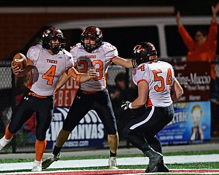 NILES, OHIO - OCTOBER 12, 2017: Howland's Jackson Deemer, left, celebrates with Garrett Deemer and Logan Gaskil after scoring a touchdown during the first half of their game Thursday night at Niles McKinley High School. DAVID DERMER | THE VINDICATOR