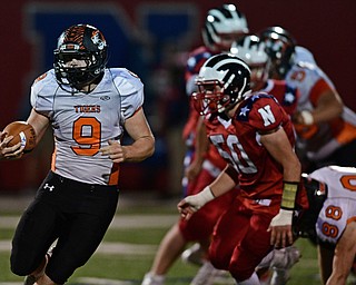 NILES, OHIO - OCTOBER 12, 2017: Howland's Hayden Parker runs with he football away from Niles' Aaron Cline during the first half of their game Thursday night at Niles McKinley High School. DAVID DERMER | THE VINDICATOR