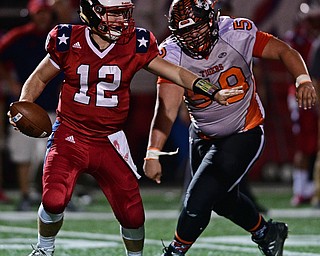 NILES, OHIO - OCTOBER 12, 2017: Niles' Jordan Soda, left, looks downfield before being asked by Howland's Jack Lambert during the first half of their game Thursday night at Niles McKinley High School. DAVID DERMER | THE VINDICATOR