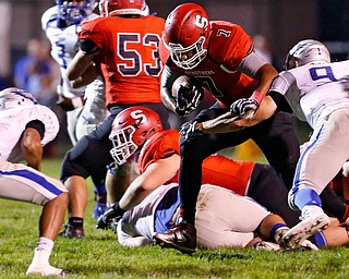 MICHAEL G TAYLOR | THE VINDICATOR- 10-13-17 FOOTBALL Hubbard Eagles vs Struthers Wildcats at Struthers High School, Struthers, OH..1st qtr., Struther's RB Wille Mitchell #7 eyes  Hubbard's Davion Daniels #4 after breaking the attempted arm tackle of Hubbard's Ryan Halavick #9