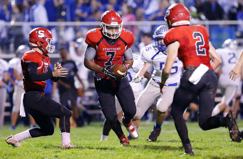 MICHAEL G TAYLOR | THE VINDICATOR- 10-13-17 FOOTBALL Hubbard Eagles vs Struthers Wildcats at Struthers High School, Struthers, OH..2nd qtr., after taking the handoff from Struthers' QB J.D. Hall #12 ,  Struther's RB Wille Mitchell #7 prepares to hand the ball to his teammate Nick Adams #2 on the reverse