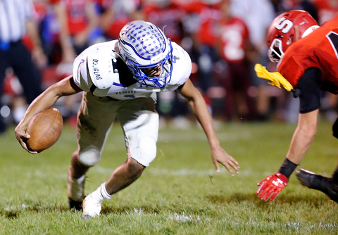 MICHAEL G TAYLOR | THE VINDICATOR- 10-13-17 FOOTBALL Hubbard Eagles vs Struthers Wildcats at Struthers High School, Struthers, OH..2nd qtr., Hubbard's QB Davion Daniels #4 escapes the would be tackle of Struthers' Connor Calabrette DL #48 as a penalty flag flies..