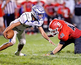 MICHAEL G TAYLOR | THE VINDICATOR- 10-13-17 FOOTBALL Hubbard Eagles vs Struthers Wildcats at Struthers High School, Struthers, OH..2nd qtr., Hubbard's QB Davion Daniels #4  escapes the would be tackle of Struthers' Connor Calabrette DL #48.