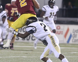 Cardinal Mooney cornerback Chris Gruber (2) is tackled by Warren Harding defensive back Kasen Lewis (21) during the first quarter as Warren Harding High School takes on Cardinal Mooney High School, Friday, Oct. 13, 2017, at Stambaugh Stadium in Youngstown...(Nikos Frazier | The Vindicator)..