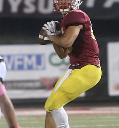 Cardinal Mooney quarterback Antonio Page (15) looks for an open receiver before launching down the field during the first quarter as Warren Harding High School takes on Cardinal Mooney High School, Friday, Oct. 13, 2017, at Stambaugh Stadium in Youngstown...(Nikos Frazier | The Vindicator)..
