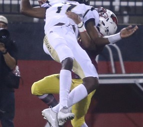 Warren Harding wide receiver Trivell Trimble (17) is taken down by Cardinal Mooney defensive back Chris Gruber (2) during the second quarter as Warren Harding High School takes on Cardinal Mooney High School, Friday, Oct. 13, 2017, at Stambaugh Stadium in Youngstown...(Nikos Frazier | The Vindicator)..
