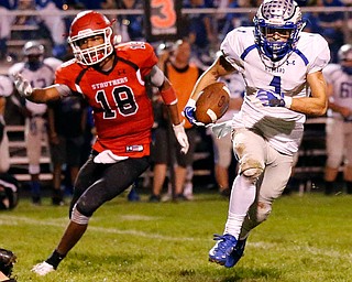 MICHAEL G TAYLOR | THE VINDICATOR- 10-13-17 FOOTBALL Hubbard Eagles vs Struthers Wildcats at Struthers High School, Struthers, OH..2nd qtr., Hubbard's WR Ray Minniti #1  takes the pitch as Struthers' Kylel Griffin DL #18 chases.