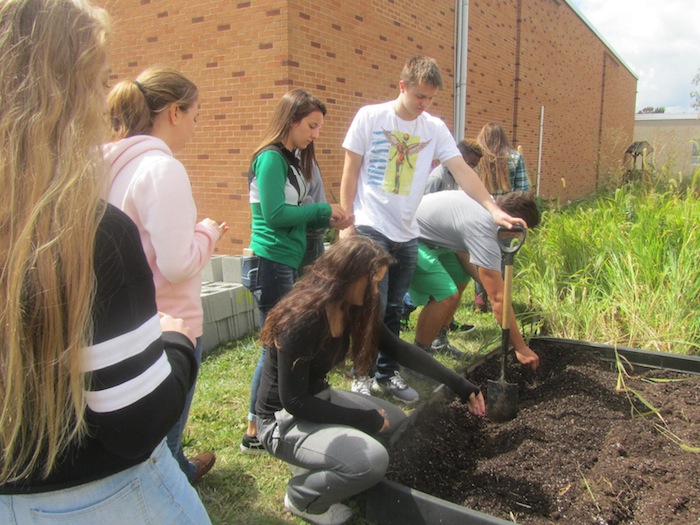 Marsha Coffee, teacher at West Branch High School, had her students plant an herb and vegetable garden during its food and fitness class as part of a Farm to Table project. Students planted lettuce, spinach, carrots and cilantro outside WBHS and tended the garden every day until it was ready to harvest. They will use the produce for smoothies, vegetable lasagna and garnishes for other dishes made in class. An article in the Washington Post stated that gardening and growing your own vegetables is not only a healthier option and more cost-effective, it can improve a child’s overall mental and physical health. At left, the class at WBHS tending the garden.
