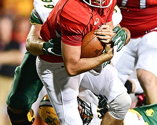 YOUNGSTOWN, OHIO - OCTOBER 14, 2017: Youngstown State's Nathan Mays is tackled by North Dakota State's Nate Tanguay during the first half of their game Saturday night at Stambaugh Stadium. DAVID DERMER | THE VINDICATOR