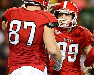 YOUNGSTOWN, OHIO - OCTOBER 14, 2017: Youngstown State's Zak Kennedy, right, celebrates with Chris Durkin after a successful field goal during the first half of their game Saturday night at Stambaugh Stadium. DAVID DERMER | THE VINDICATOR