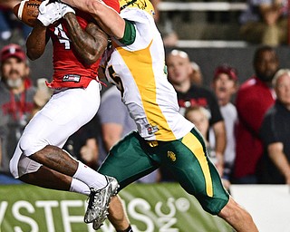 YOUNGSTOWN, OHIO - OCTOBER 14, 2017: Youngstown State's Damoun Patterson catches a touchdown pass behind North Dakota State's Levi Jordheim during the first half of their game Saturday night at Stambaugh Stadium. DAVID DERMER | THE VINDICATOR