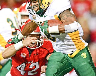 YOUNGSTOWN, OHIO - OCTOBER 14, 2017: North Dakota State's Bruce Anderson runs the football away from Youngstown State's Armand Dellovade during the first half of their game Saturday night at Stambaugh Stadium. DAVID DERMER | THE VINDICATOR
