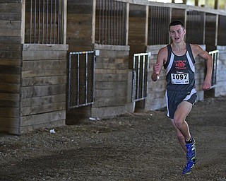 BAZETTA, OHIO - OCTOBER 14, 2017: LaBrae's Jakob Rose sprints to the finish line through a barn during the Division 3 race during the Sim Earich Invitational, Saturday morning at the Trumbull County Fair Grounds. DAVID DERMER | THE VINDICATOR