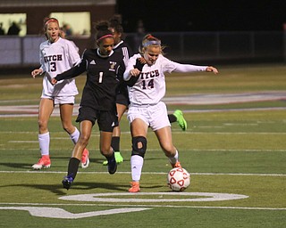     ROBERT K. YOSAY  | THE VINDICATOR..Soccer Sectionals as Austintown Fitch  played  Warren Harding  at Fitch .. The Falcons won 2-0..Fitchs #14  Riley Galloway  drives down the field past Harding #1 Desi Powell during first half action behind them is #13 Abby Knight... .-30-