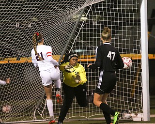     ROBERT K. YOSAY  | THE VINDICATOR..Soccer Sectionals as Austintown Fitch  played  Warren Harding  at Fitch .. The Falcons won 2-0. #21 Lauren Dolak a senior makes an attempt at a goal as Harding   India Stovell  blocks the kick.  Harding #47 Karli Heilman  looks on during first half action...-30-