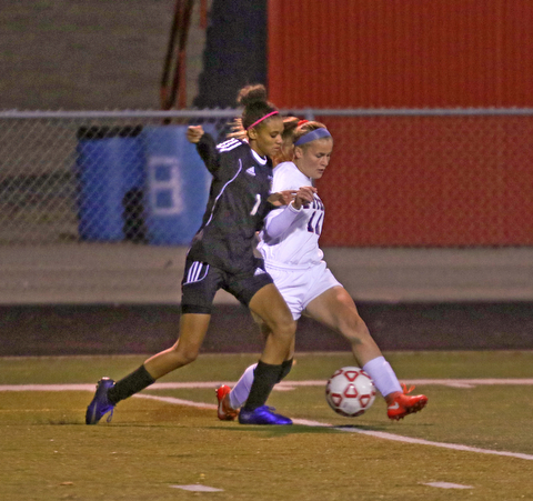    ROBERT K. YOSAY  | THE VINDICATOR..Soccer Sectionals as Austintown Fitch  played  Warren Harding  at Fitch .. The Falcons won 2-0..Harding #1 Desi Powell works to try to get the ball as Fitch's #11 Bailey Fritz drives down field.-30-