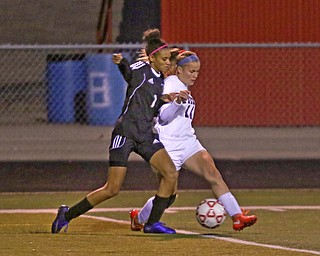     ROBERT K. YOSAY  | THE VINDICATOR..Soccer Sectionals as Austintown Fitch  played  Warren Harding  at Fitch .. The Falcons won 2-0..Harding #1 Desi Powell works to try to get the ball as Fitch's #11 Bailey Fritz drives down field.-30-