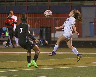     ROBERT K. YOSAY  | THE VINDICATOR..Soccer Sectionals as Austintown Fitch  played  Warren Harding  at Fitch .. The Falcons won 2-0 Fitchs #3 Sydney Spencer  bounces the ball back into play  as #7 Harding Kyvetta Carmichail.. looks on...-30-