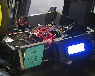 Neighbors | Zack Shively  .Librarian Missy Williams opened the library's 3-D printer to describe how it works. She also used it to explain a story where she had to troubleshoot the machine.
