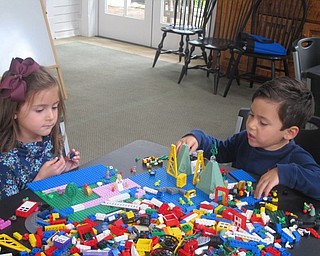 Neighbors | Zack Shively  .The children at Listen and Lego listen to a story and build with Legos for the remaining time left in the hour. Librarian Vikki Peck gave them a box full of Legos and handed them special pieces.